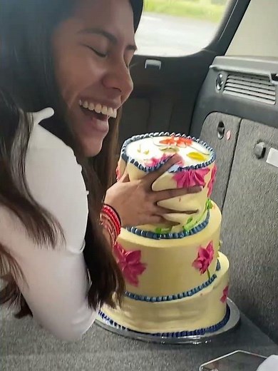 Woman tries to save tilted cake during car ride in Guadalajara, Mexico