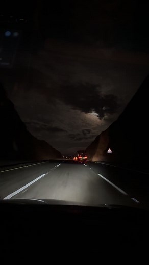 Nighttime Highway Drive with Moonlit Scenery