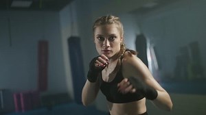 Slow motion, female fighter trains his punches, training in the boxing gym, female trains a series of punches, woman power.