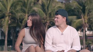 Young Woman in Dress Puts Hands and Head on Guy Shoulder