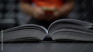 Reading old textbook in university library, read book or relaxing in vintage black background. Reading is complex cognitive process of decoding symbols to derive meaning communication information. Stock Video