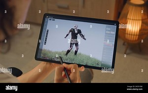 Male 3D designer creating 3D animation of video game character in design application on modern digital tablet computer using stylus Stock Photo - Alamy