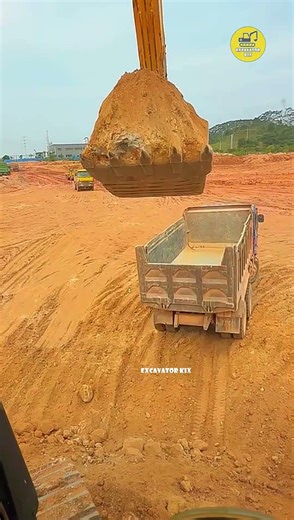 Excavators Load Soil Onto Trucks