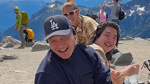 Hungry squirrel climbs all over snacking hiker