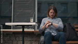 Man with smartwatch using voice recorder recognition audio message command outside on street. Deadline, technology and people concept - creative man with smartwatch using voice command recorder