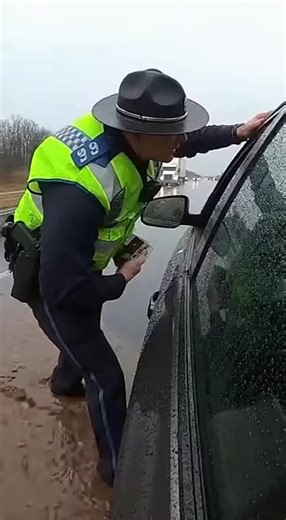 A routine traffic stop turned into a muddy nightmare for a local police officer. While leaning into a driver's window to check documents, a massive semi-truck sped past in the adjacent lane. The truck's wheels hit a deep puddle of standing water, sending a violent tidal wave of brown sludge directly onto the unsuspecting officer. Within seconds, the officer was transformed into a mud sculpture, completely coated from his hat to his boots. The shocking moment was caught on a dash camera, highligh