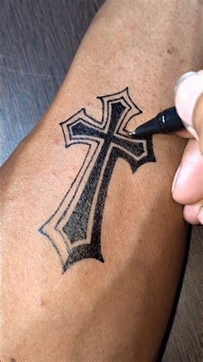DIY cross tattoo design with gel pen on wrist