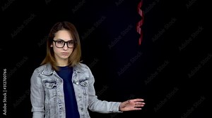 Sad young woman let go of heart-shaped balloon. A sad woman stands with helium balls on a black background. Valentine's Day is the day of all lovers.