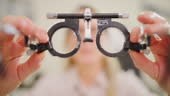 Optometrist testing eyes with a universal messbrille phoropter tool...
