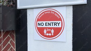 COVID-19, 2-metre social distancing signage on a public street in the UK. Filmed October 2020. Stock Video