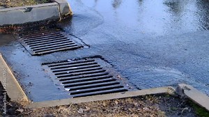 water from spring puddles flows down the drain