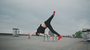 Guy dancing breakdance on the roof - Free Stock Video