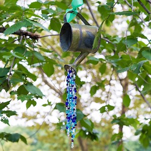 This adorable DIY watering can suncatcher is the perfect gift for a friend's backyard or even your own! 💦 | LittleThings