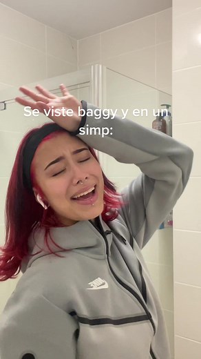 Red-Haired Individual Reacts in a Modern Bathroom