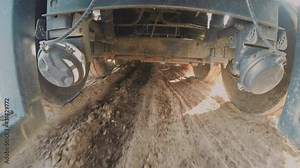 Truck driving on Muddy Terrain. 4K camera is under a truck while driving on mud and water, Interesting point of view. 4x4 Truck Drive. 4k footage.