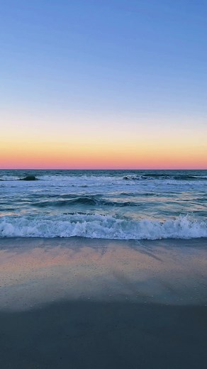 Peaceful Beach Sunset Over Gentle Ocean Waves