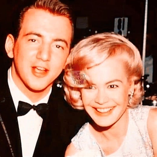 "Sandra Dee and her husband, Bobby Darin, are photographed at the premiere of their romantic comedy, If A Man Answers, in 1962. Held at the famed Pacific’s Cinerama Theatre in Hollywood, the event drew a glamorous crowd eager to see the real-life couple share the screen. Dee, known for her roles in films like Gidget (1959), dazzled in a pastel gown beside Darin, who had recently transitioned from music icon to actor after his success in Come September (1961). Their chemistry, both on and off the