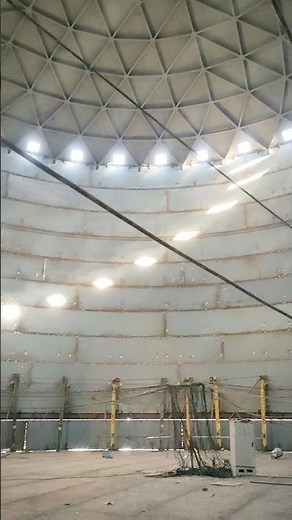 This is a large aboveground fixed roof storage tank under construction.