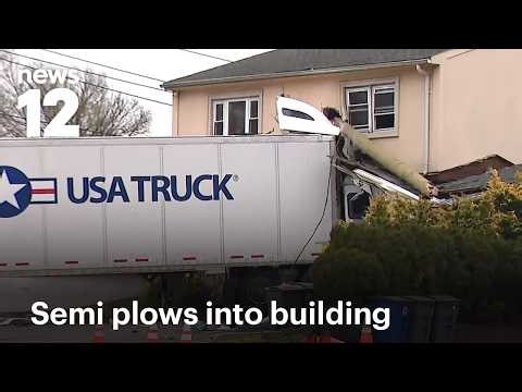 Tractor‑trailer crashes into NJ building off Route 3, driver rescued