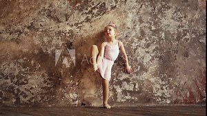 Child gymnast picks up a foot in the splits. Children's sports. flexibility and stretching. Slow motion