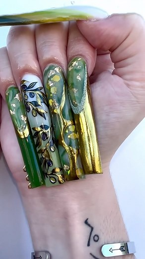 Love watching @thenailbender do beautiful and intricate nails like this set 🤩💚✨ #thenailbender #AbstractNails #stpatricksdaynails #glitternails #greennails #goldnails #springnails #MarbleNails #nailsmagazine | NAILS Magazine