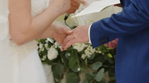 Bride and groom wear their wedding ring