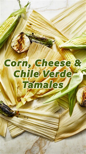 These norteño-style tamales have irresistible bites of fresh corn mixed into the masa, making them perfect for summer! That sweet corn masa is wrapped around a gently spicy, savory filling of roasted chile verde, sautéed onions, and melted quesadilla and Oaxaca cheese. It's truly a phenomenal combination. Recipe is on patijinich.com #tamales #sweetcorn #chileverde