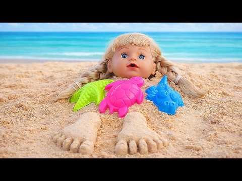 Emily the doll is playing on the beach with her stuffed dog!