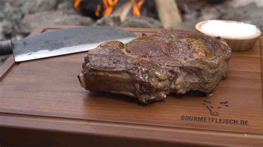 Village style monster steak grilled on a burning stone