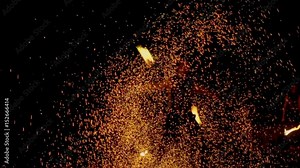 An amazing fire show at night. A man spinning fire. Long shot