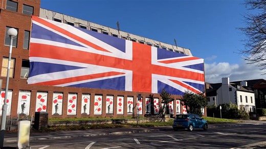 Property developer drapes huge Union Jack flag on old council HQ after planning row