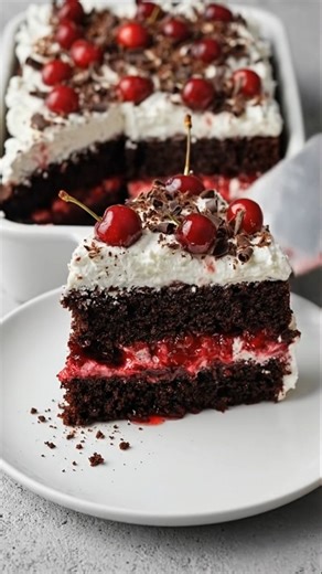 🍒 Black Forest Cherry Cream Cake | Fudgy, Luscious, and Bakery-Worthy 🍫 There’s something timeless about a tall slice of Black Forest Cherry Cream Cake sitting proudly on the table. That deep, dark chocolate cake… the sweet cherry filling tucked between thick layers… and that fluffy cloud of whipped cream on top. It’s dramatic, nostalgic, and completely irresistible. This Black Forest cake is rich and unbelievably moist, with fudgy chocolate layers and a juicy cherry center that melts into eve
