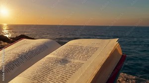 book on the beach at sunset, Open book illuminated by sunlight at sunset by the ocean. World book day created with generative ai.