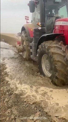 Heavy-Duty Tractor Deep Plows Flooded Farmland