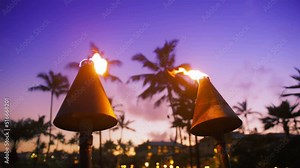 Hawaii sunset with fire torches. Hawaiian icon, lights burning at dusk at beach resort or restaurants for outdoor lighting and decoration. Cozy atmosphere, dream trip, tropical island, summer vacation