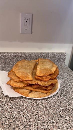 Homemade Chebureki Dough: 240 ml boiling water, mix with 1 tsp salt, 4 tbsp oil, and 500 g flour. Knead a firm, tight dough. Cover and let it rest for 30 minutes. Filling: I mixed ground beef and ground turkey — 450 g each (you can also use beef and pork, whatever you prefer). Finely chop 1 onion, add salt and black pepper to taste, and pour in 200 ml cold water. Mix well — the filling should be juicy. After the dough has rested, divide it into balls about 70 g each. I got 10 full balls and one 