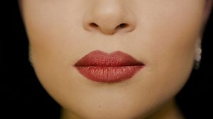 The girl makes an air kiss with her lips