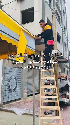 Installing a Yellow Fabric Awning on Urban Building