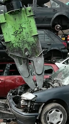 Demolition Machine Crushing a Car in Scrapyard