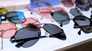 Popular optical store with huge selection of stylish sunglasses. On store window there models of glasses of different shapes and colors. In store you can choose glasses for any age and for any budget.