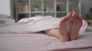 Feet of a person resting on a bed - Free Stock Video