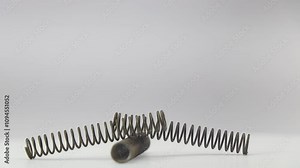 Metal coil spring detailed view on a rotating display. Spare metal springs for various applications