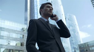 Businessman on the phone in a city - Free Stock Video