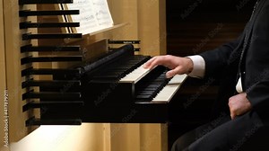 Hands close up of an organist playing on the pedal board of a pipe organ in a church. Slow motion. (4k, 60p) Stock Video