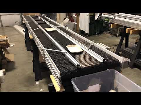 Moving Trays with Safe Conveyor, Inc. using adjustable custom guide rails.