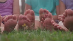 Cute Little Kids Barefeet In Green Grass Wiggling Toes
