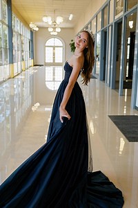 A $12 Thrift Store Dress Changed Everything. I was always the quiet one, the girl with promise — but promise doesn’t cover rent. With Dad gone and Mom barely making ends meet, prom wasn’t even a thought. That is, until Grandma suggested we check out the thrift store for a dress. At Goodwill, most of the dresses looked ancient — except one. A midnight blue gown with lace on the back. It looked brand new, and the price? Just $12. Grandma altered it for me, and while adjusting the zipper, we found 