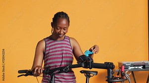 Engineer setting up bike repair stand, using it to adjust derailleur and cables, fixing broken wheels, studio background. Professional assembling workstand to maintain bicycle at eye level, camera A