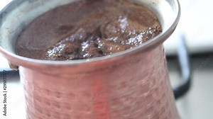 Cooking coffee in the copper pot close up view