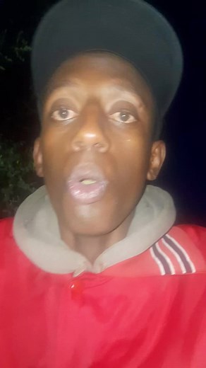 Nighttime Outdoor Fashion: Red Jacket and Colorful Cap